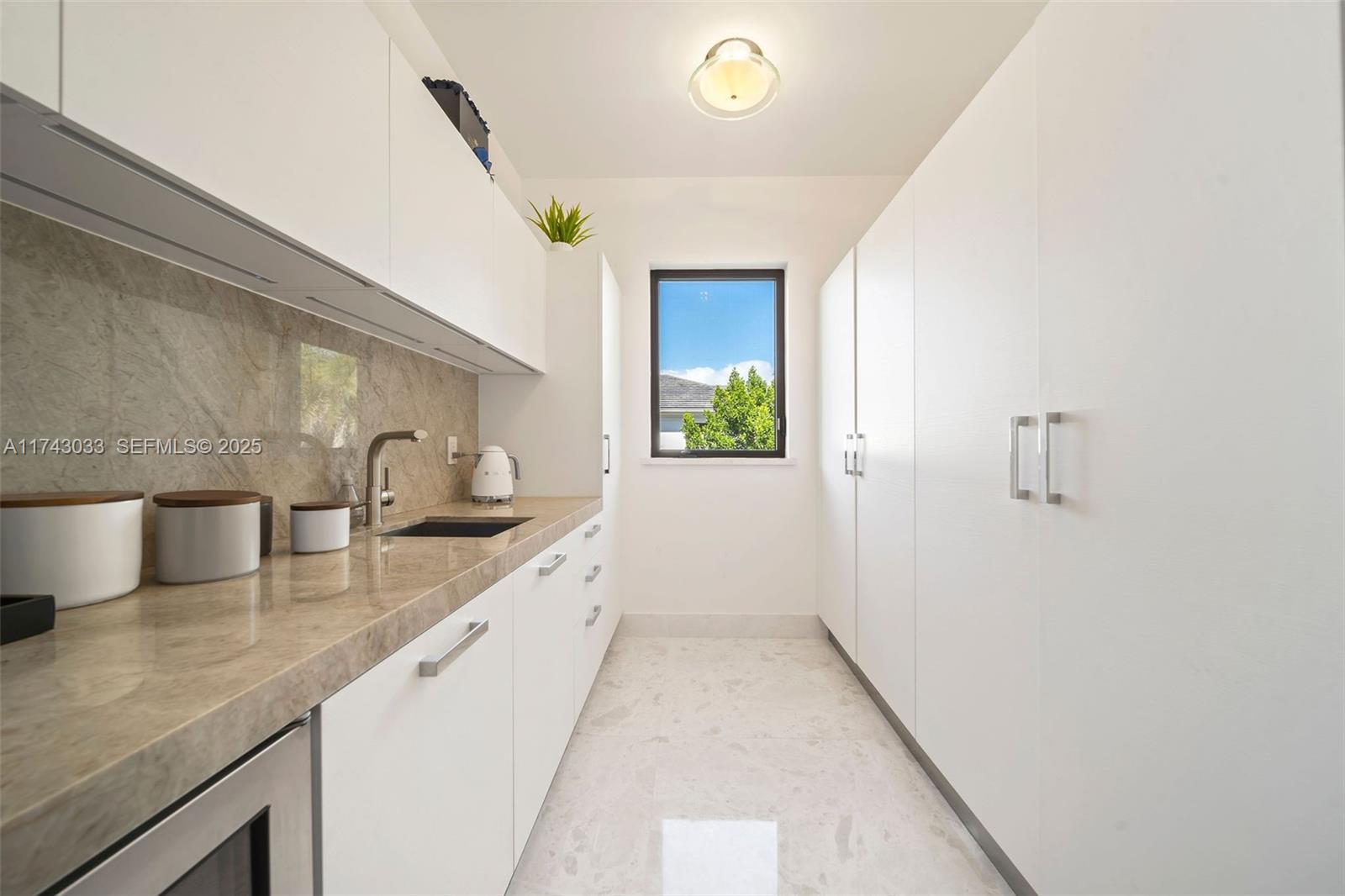 8955 Southwest 63rd Court Pinecrest, FL 33156 - Photo 44 of 59 a kitchen with a sink and cabinets