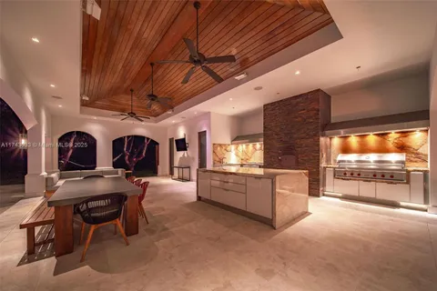 a kitchen with a table a refrigerator a cabinets and stools