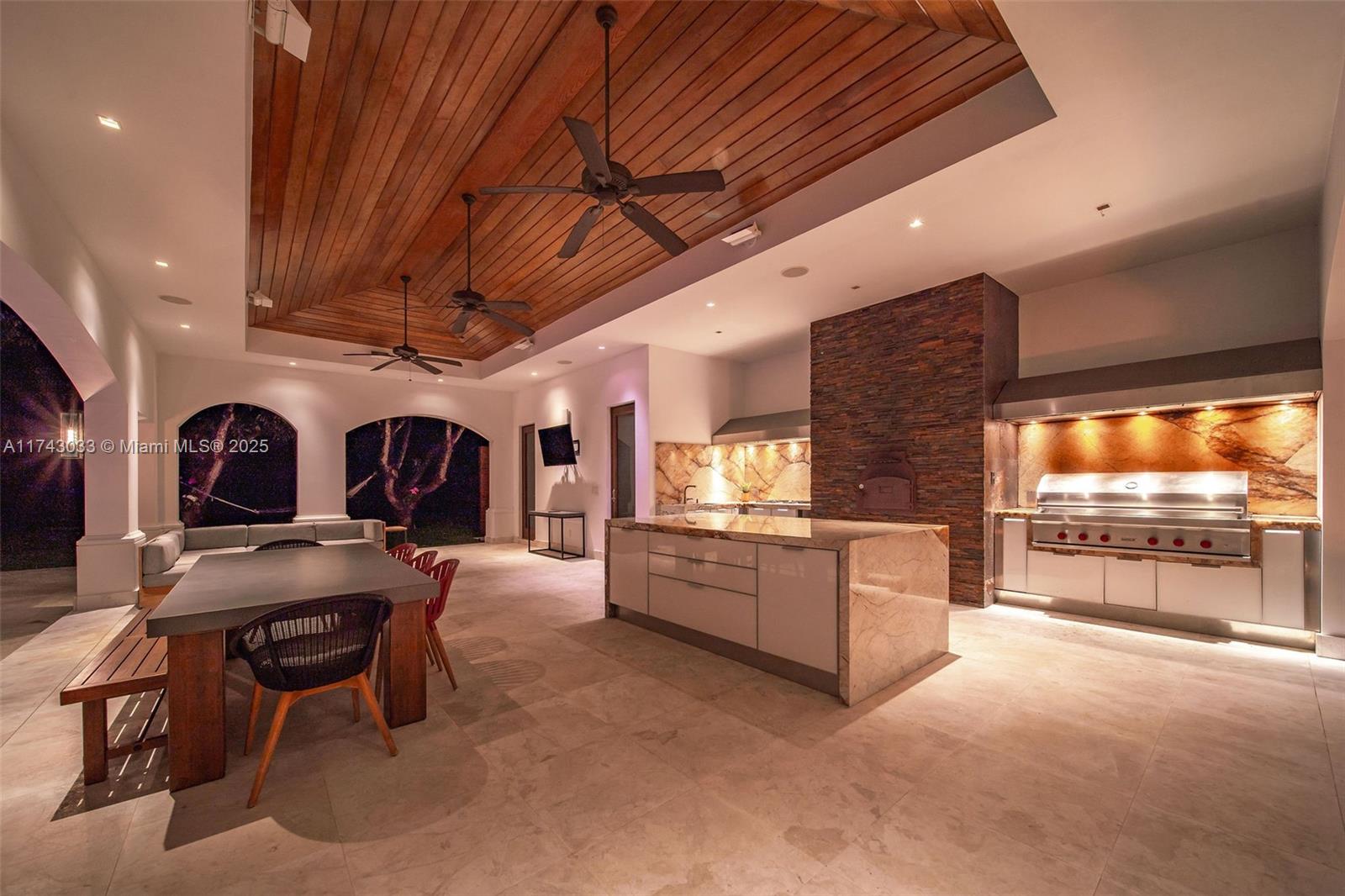 8955 Southwest 63rd Court Pinecrest, FL 33156 - Photo 5 of 59 a large white kitchen with a large window