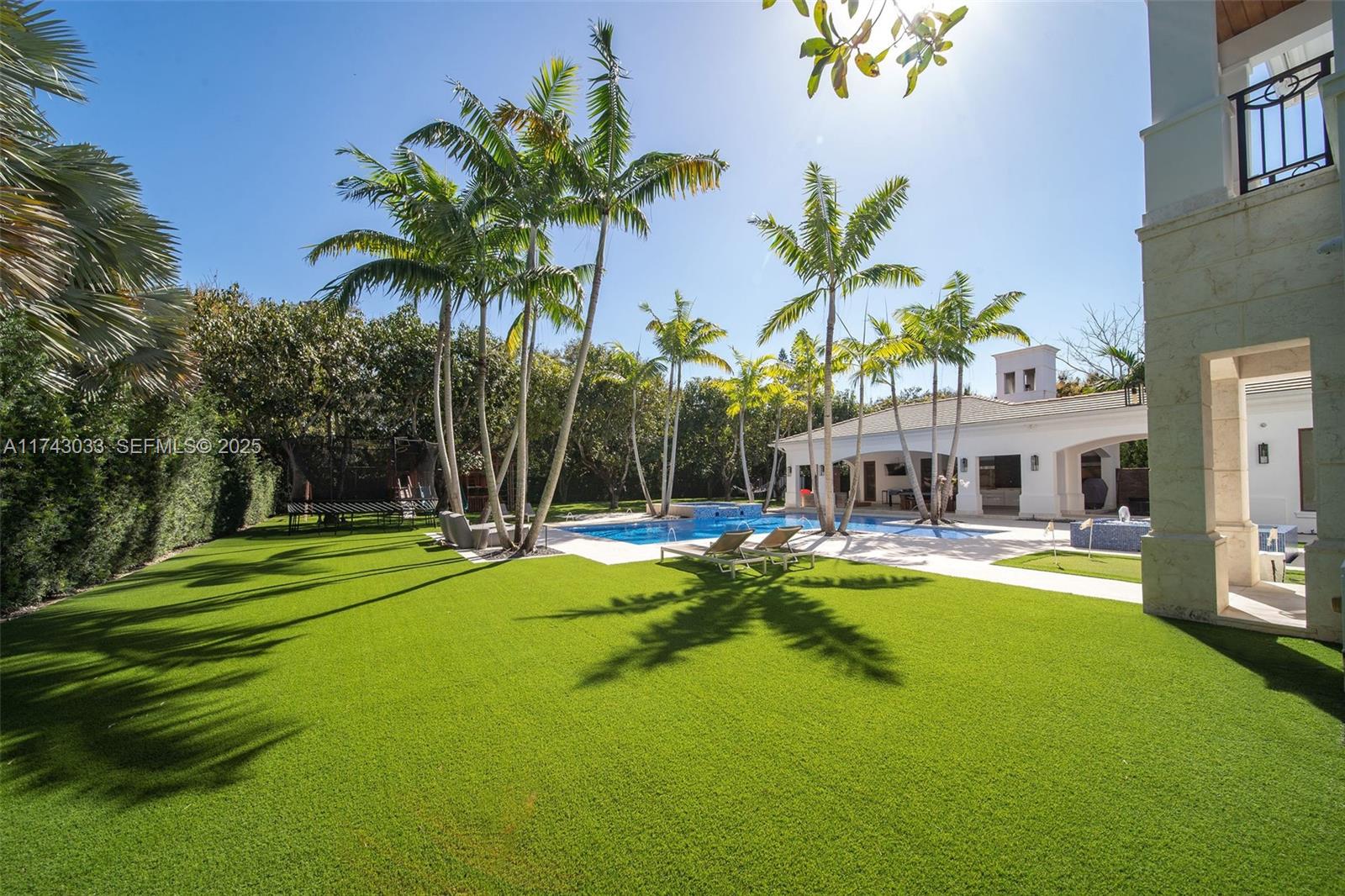 8955 Southwest 63rd Court Pinecrest, FL 33156 - Photo 6 of 59 a view of a house with swimming pool and sitting area