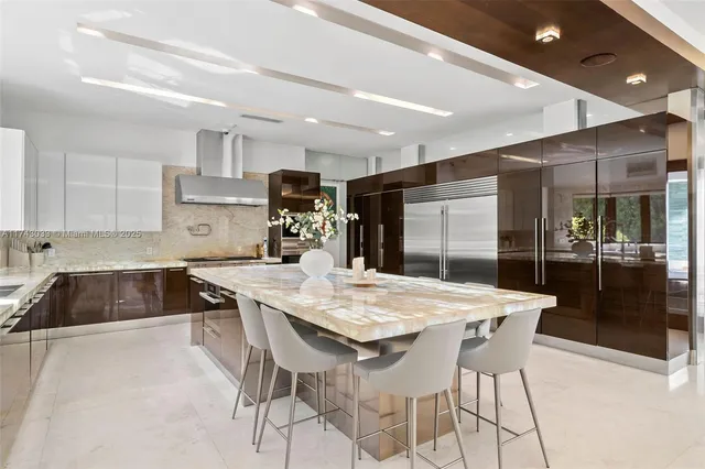 a kitchen with stainless steel appliances granite countertop a stove top oven a sink a counter space and cabinets