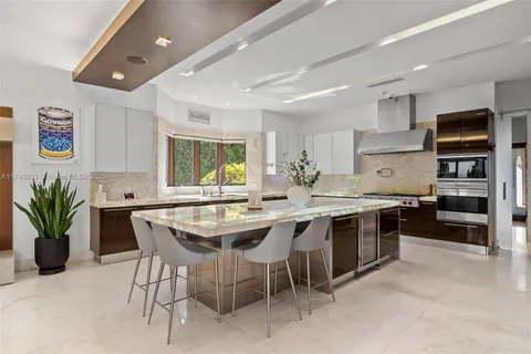 a kitchen with granite countertop a refrigerator and a sink