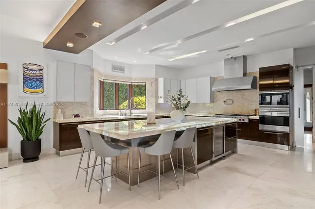a kitchen with granite countertop a refrigerator and a sink