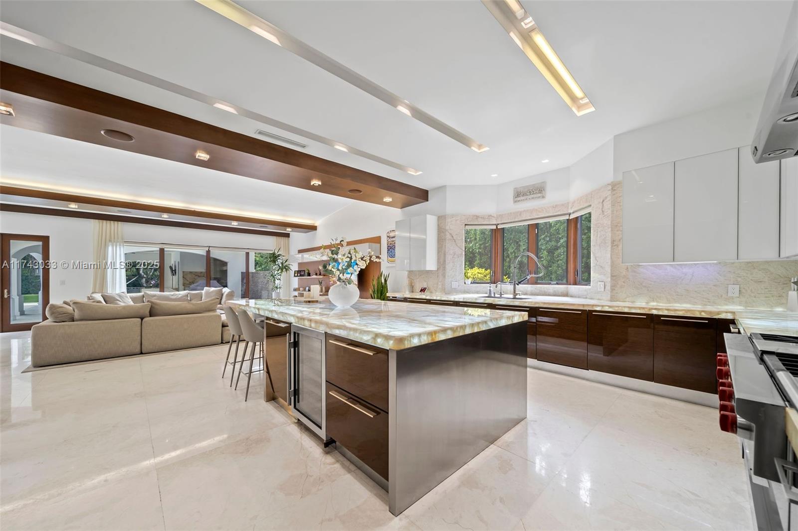 8955 Southwest 63rd Court Pinecrest, FL 33156 - Photo 10 of 59 a kitchen with counter top space and living room