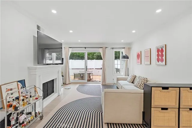 a living room with furniture a large window and a fireplace
