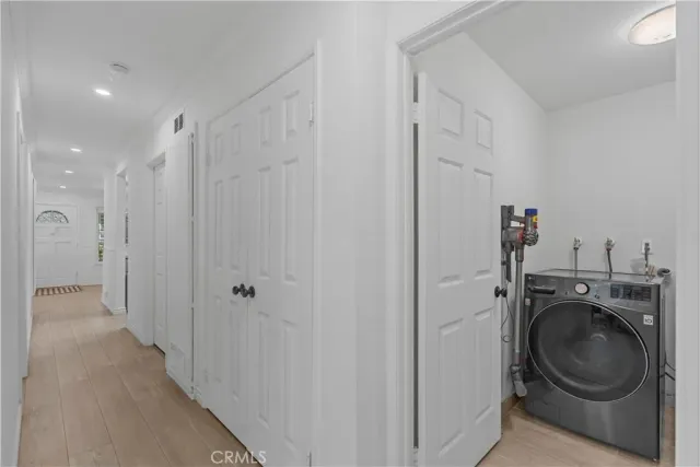 a view of a storage & utility room with a washer dryer