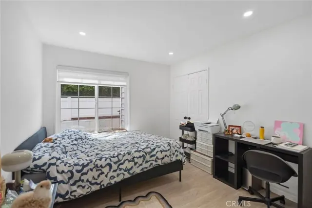 a bedroom with a bed and a desk