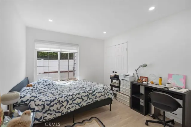 a bedroom with a bed and a desk