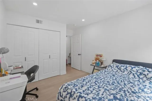 a bedroom with a bed and a chair