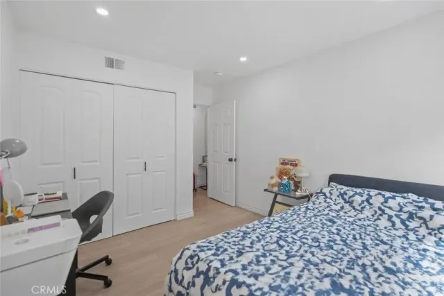 a large bed sitting in a bedroom next to a window