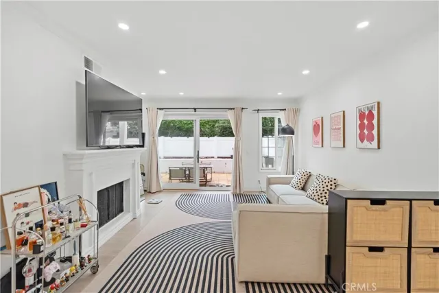 a living room with furniture and view of kitchen
