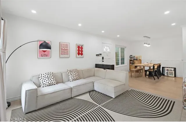 a living room with furniture and view of kitchen