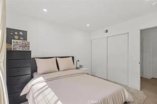 a bedroom with a bed and a closet