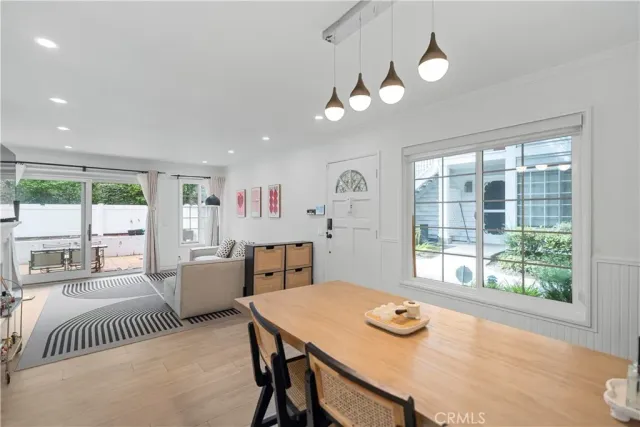 a view of a dining room with furniture wooden floor and a chandelier