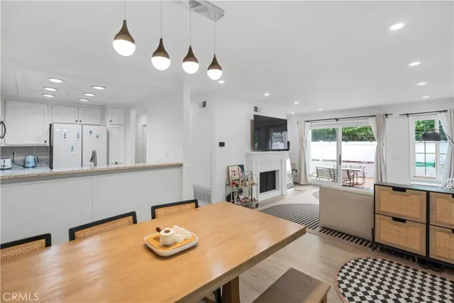 a room with stainless steel appliances kitchen island a table and chairs in it