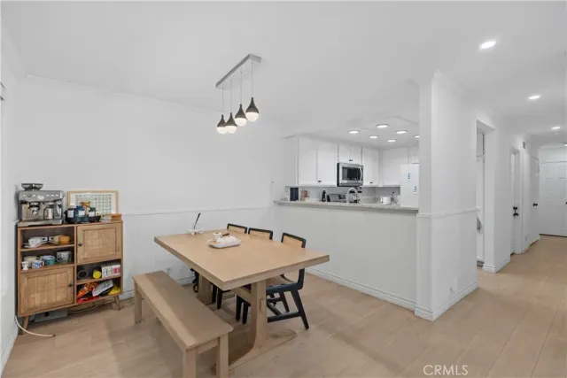 a kitchen with stainless steel appliances a stove a sink and a refrigerator