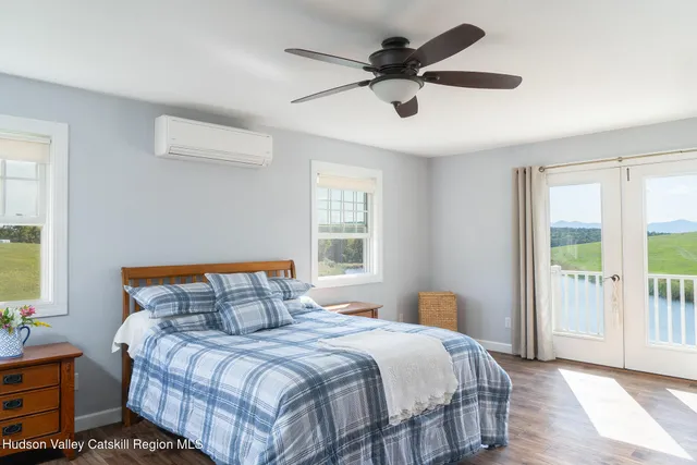a bedroom with a large bed and a large window