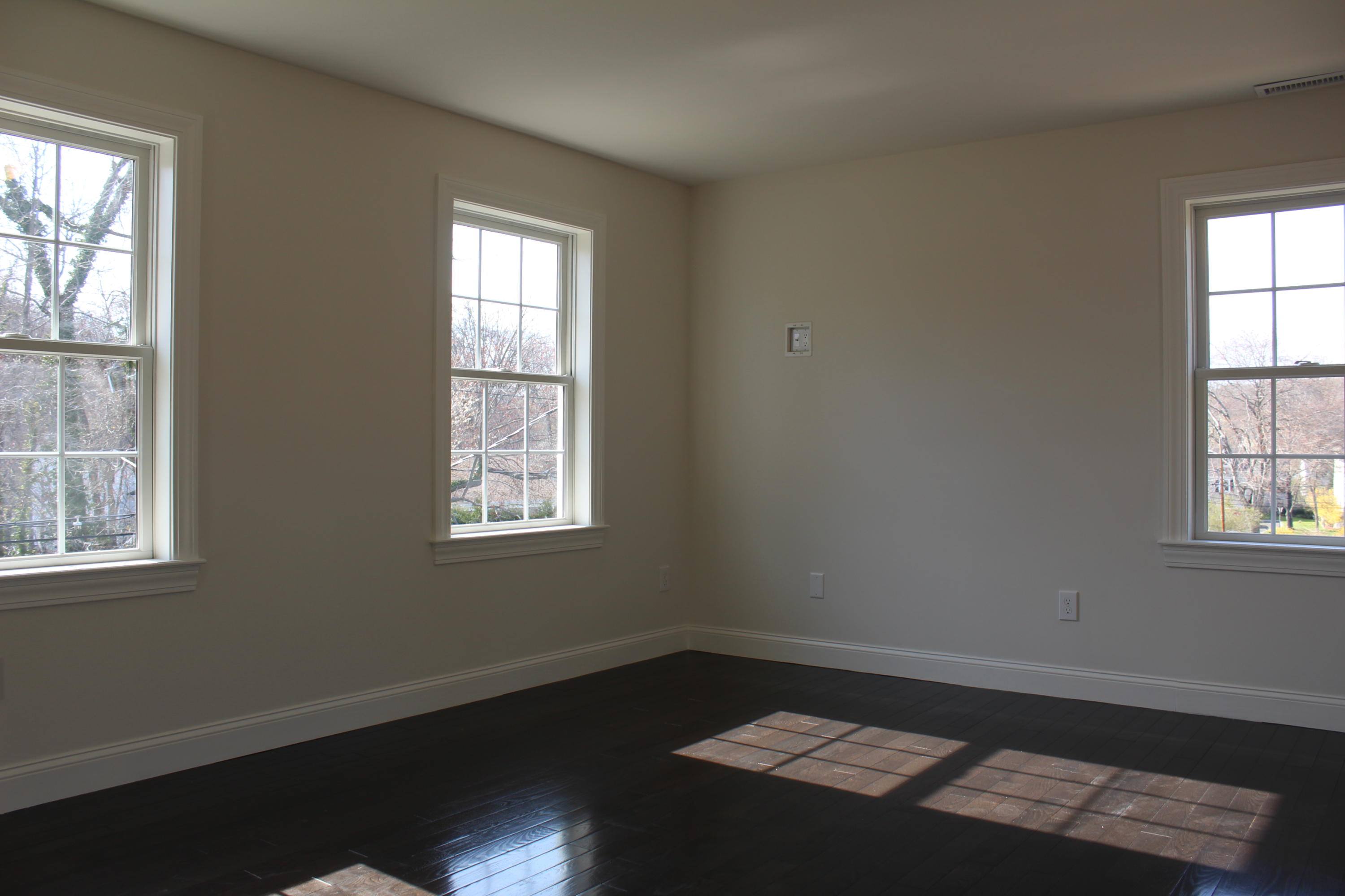 16 Knollwood Road Norwalk, CT 06854 - Photo 14 of 29 an empty room with wooden floor and windows