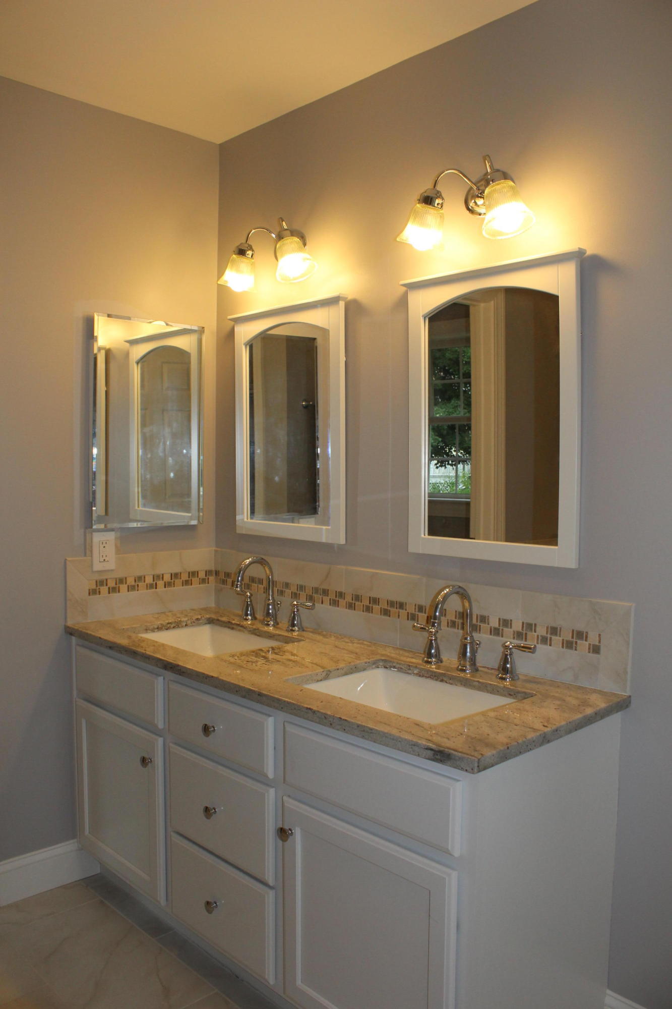 16 Knollwood Road Norwalk, CT 06854 - Photo 17 of 29 a bathroom with double vanity sinks and a mirror