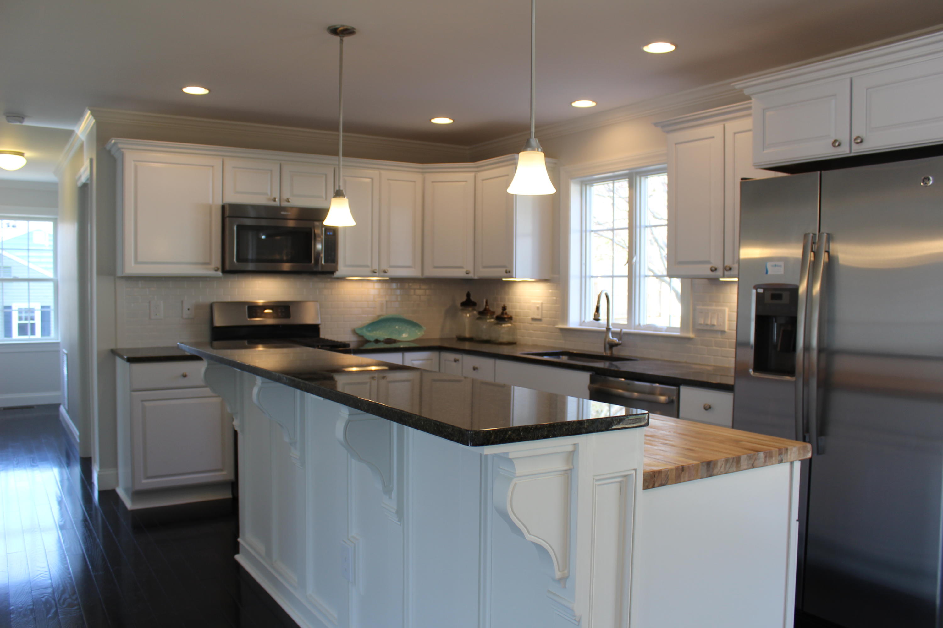16 Knollwood Road Norwalk, CT 06854 - Photo 5 of 29 a kitchen with kitchen island granite countertop a sink stainless steel appliances and white cabinets