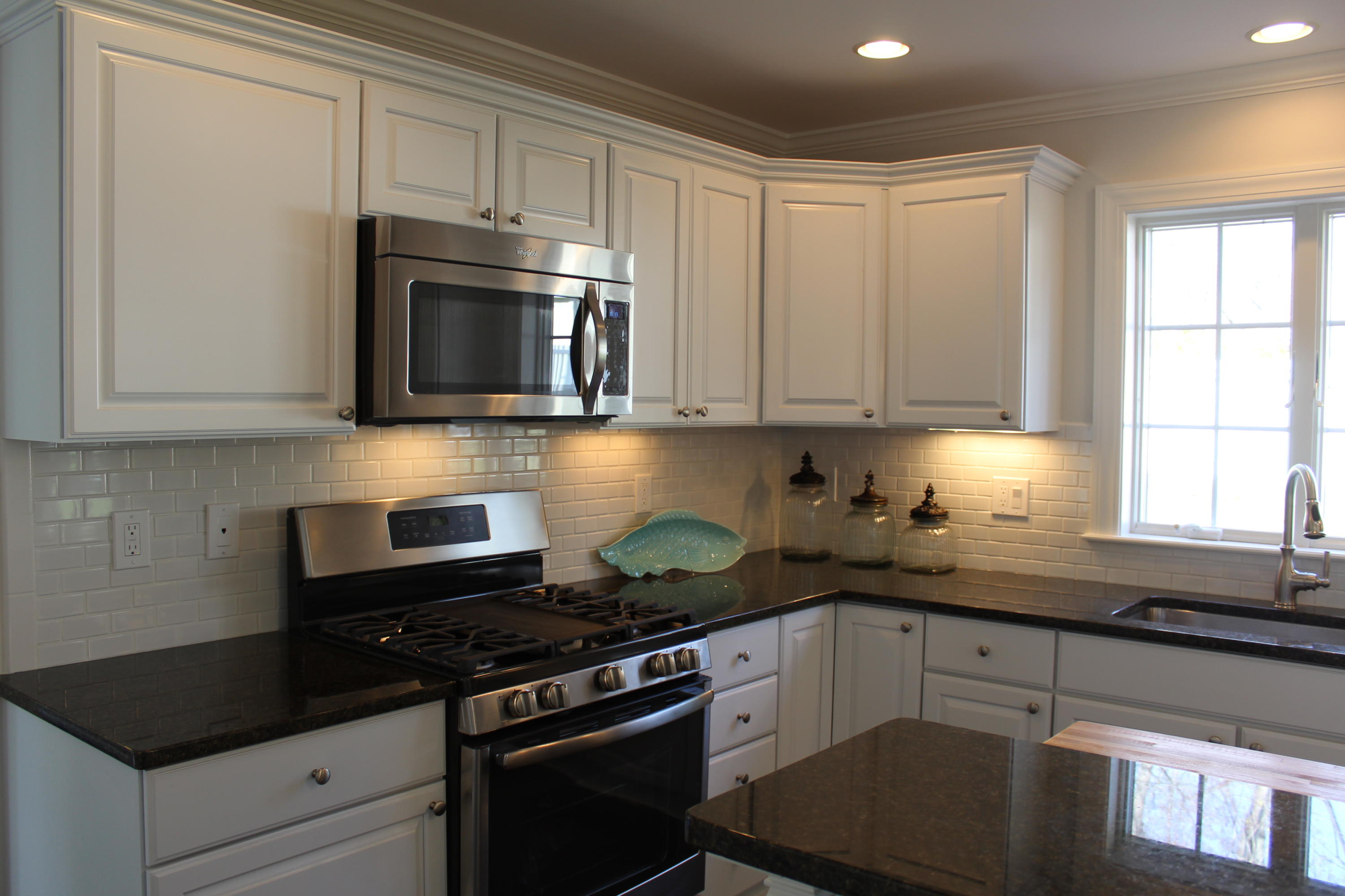 16 Knollwood Road Norwalk, CT 06854 - Photo 7 of 29 a kitchen with granite countertop white cabinets and stainless steel appliances