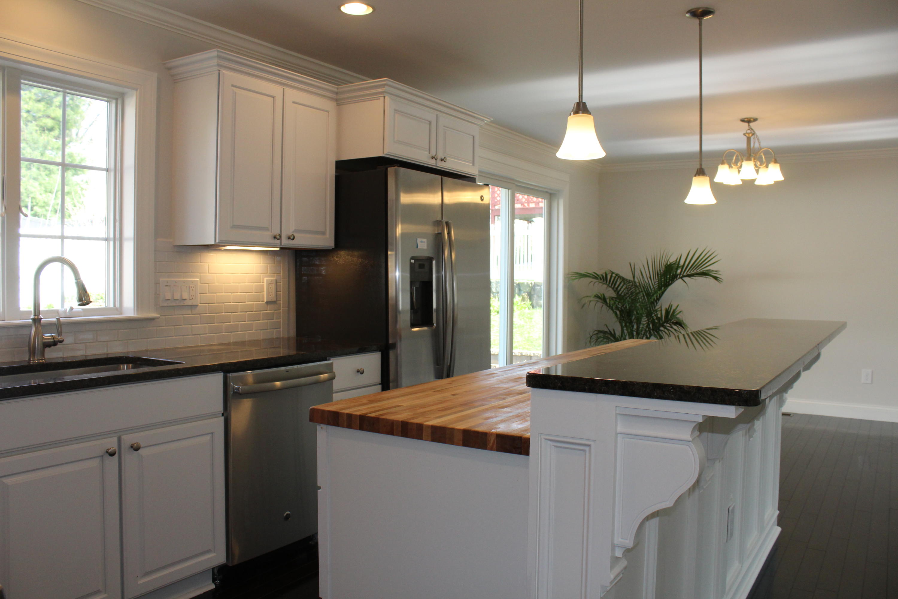 16 Knollwood Road Norwalk, CT 06854 - Photo 8 of 29 a kitchen with stainless steel appliances granite countertop cabinets and a chandelier