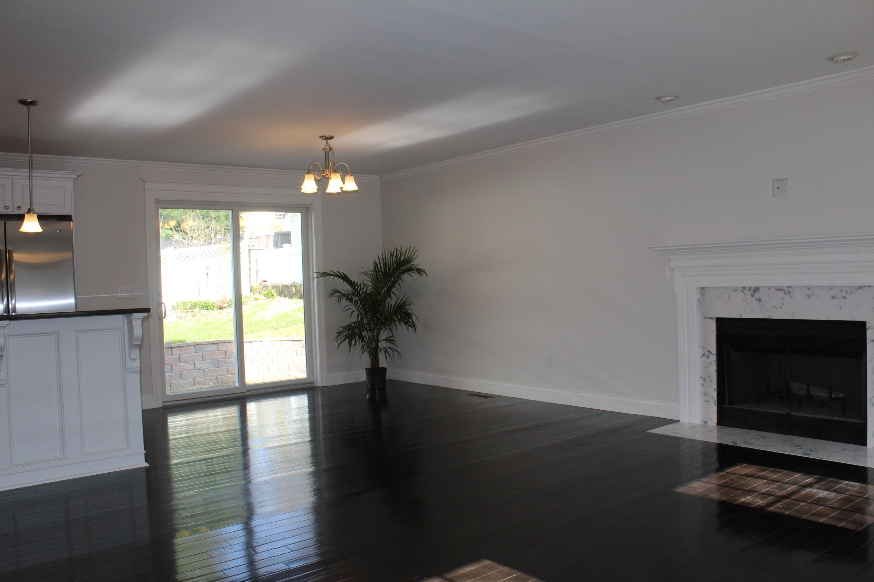 16 Knollwood Road Norwalk, CT 06854 - Photo 10 of 29 a view of empty room with wooden floor and fireplace