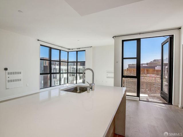 a view of kitchen with furniture and refrigerator