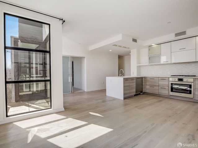 a view of a kitchen with a sink and a refrigerator