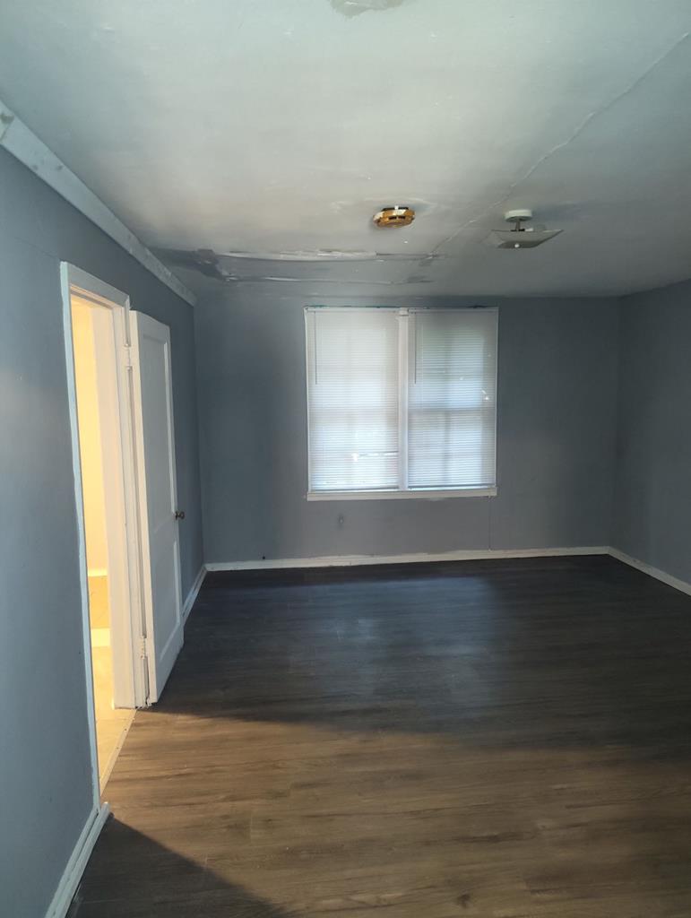 2738 Baldwin Street Columbus, GA 31906 - Photo 11 of 13 an empty room with wooden floor and windows