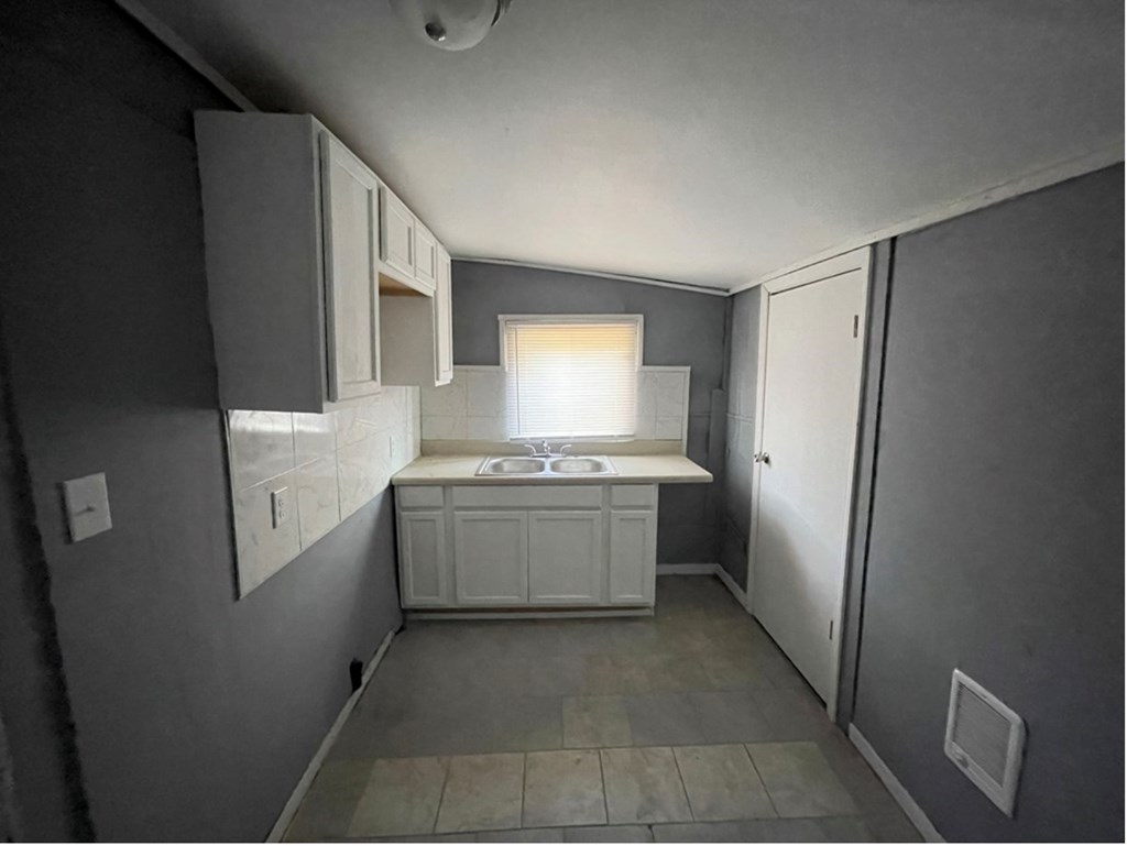 2738 Baldwin Street Columbus, GA 31906 - Photo 5 of 13 a kitchen with a refrigerator and a stove