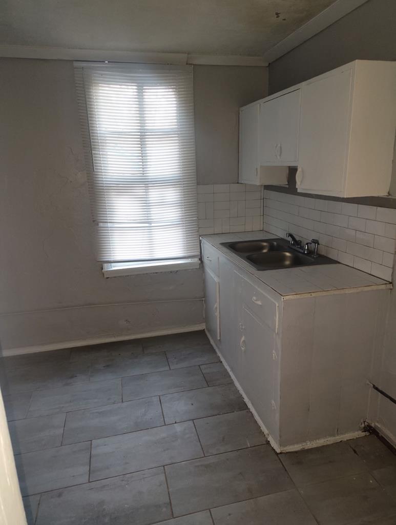 2738 Baldwin Street Columbus, GA 31906 - Photo 9 of 13 a kitchen with a sink a stove and cabinets