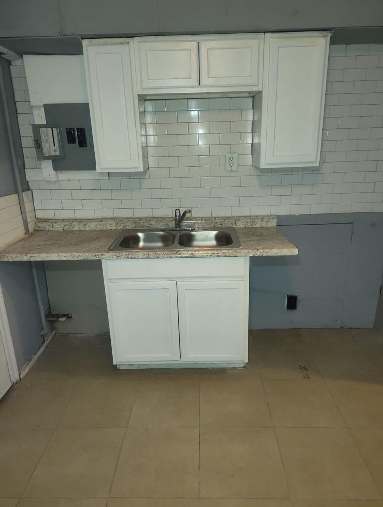 2738 Baldwin Street Columbus, GA 31906 - Photo 10 of 13 a kitchen with stainless steel appliances granite countertop a sink stove and cabinets