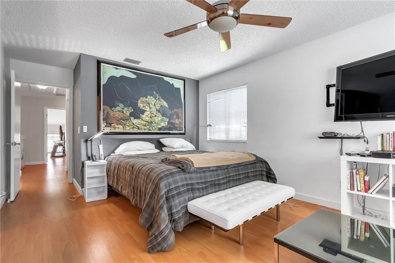 6751 Boca Pines Trail, Unit F Boca Raton, FL 33433 - Photo 19 of 24 a bedroom with a bed and a flat screen tv