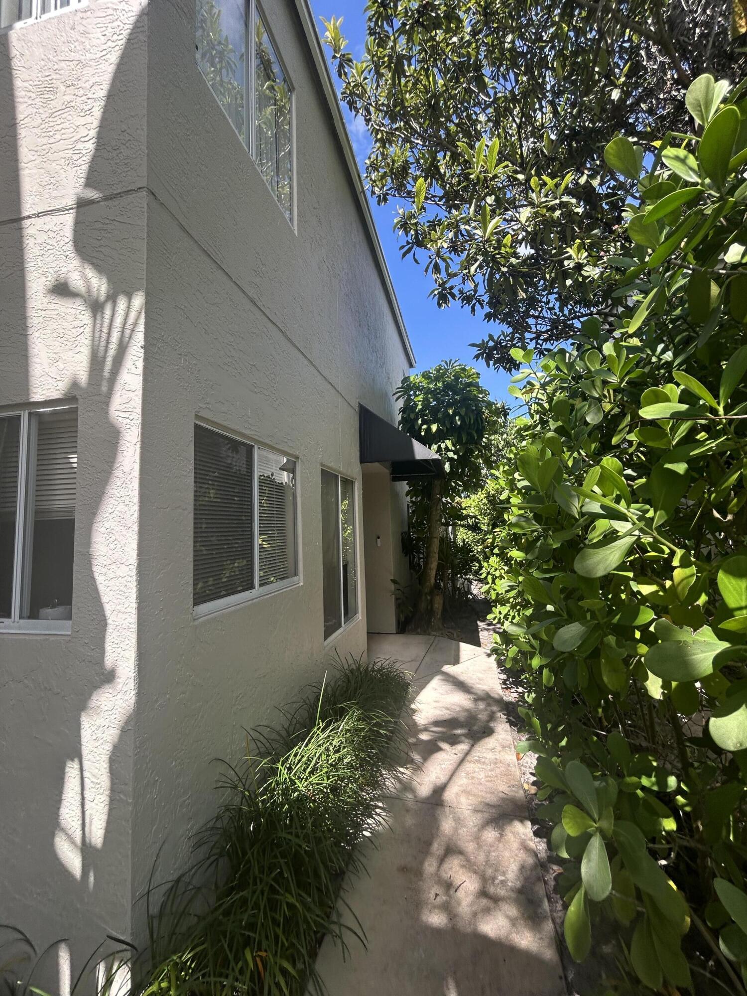 6751 Boca Pines Trail, Unit F Boca Raton, FL 33433 - Photo 24 of 24 a backyard of a house with yard and outdoor seating