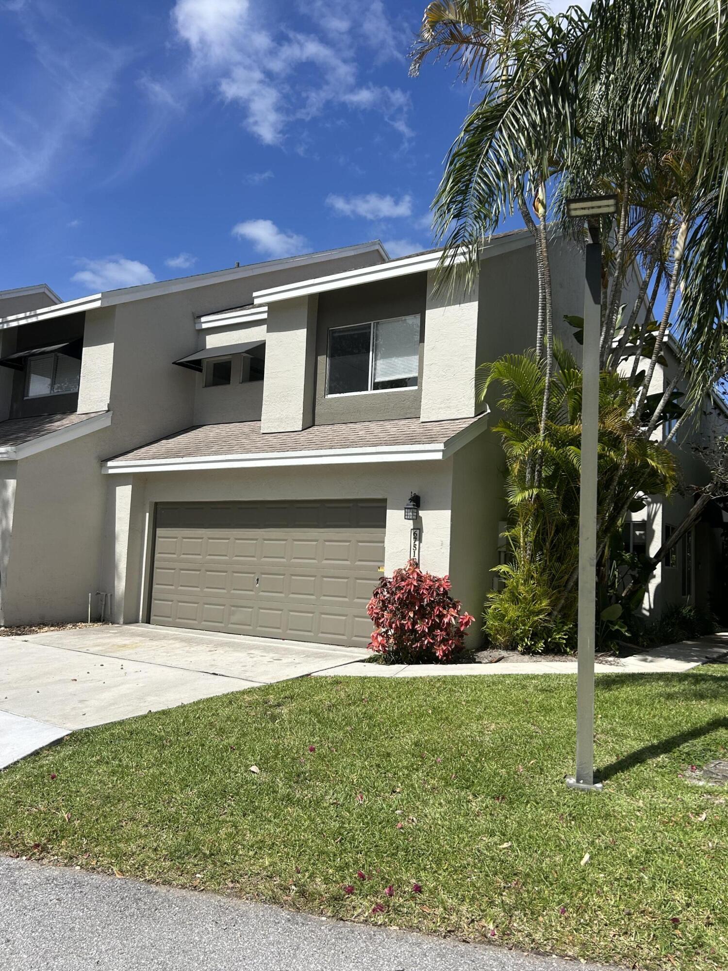 6751 Boca Pines Trail, Unit F Boca Raton, FL 33433 - Photo 4 of 24 a front view of a house with a yard