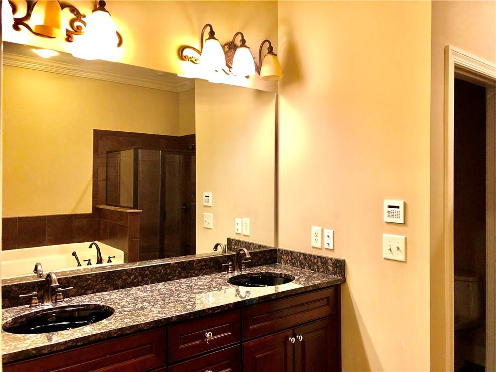10575 Bent Tree View Duluth, GA 30097 - Photo 17 of 20 a bathroom with a granite countertop sink and a mirror