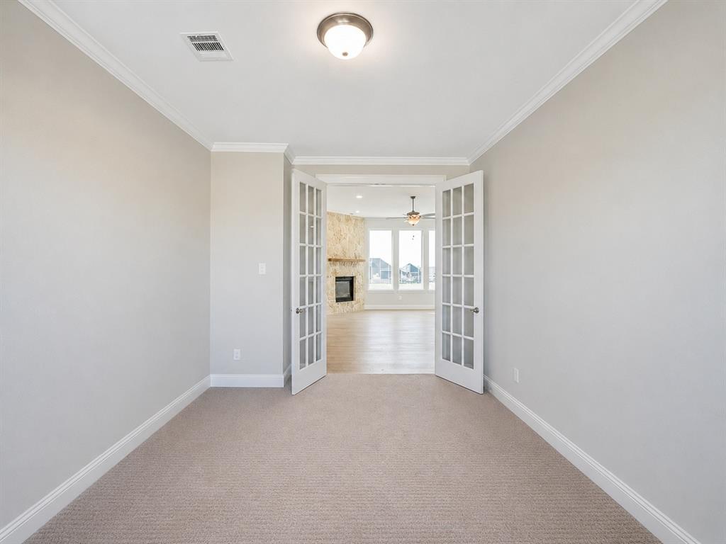 6209 Cupleaf Road Flower Mound, TX 76226 - Photo 21 of 29 Carpeted room featuring crown molding, baseboards, and a semi-flush mount light fixture