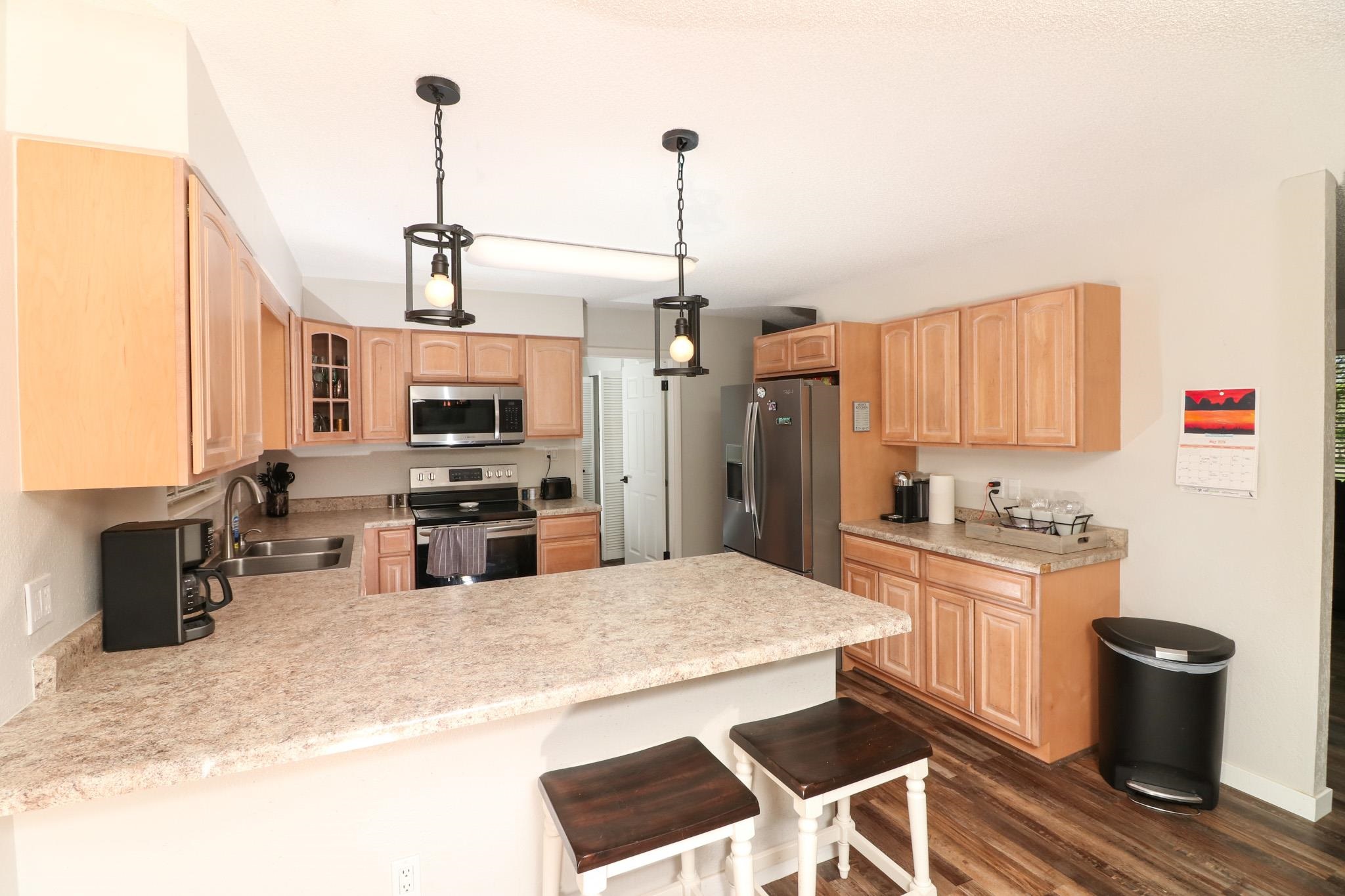 607-28 28 3/4 Road Grand Junction, CO 81506 - Photo 8 of 42 a kitchen with stainless steel appliances kitchen island granite countertop a sink and cabinets