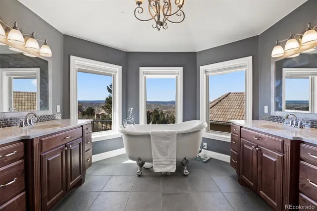 a living room with a table chairs and a sink