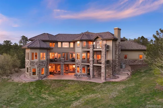 a view of a house with floor to ceiling windows and a table