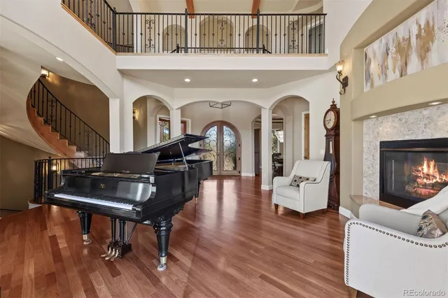 a living room with furniture a fireplace and wooden floor