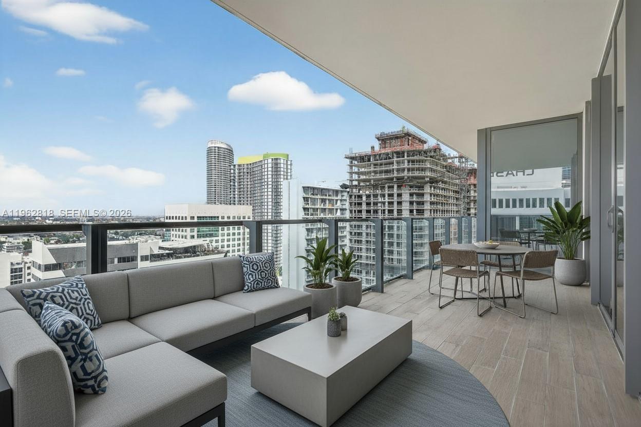 88 Southwest 7th Street, Unit 2402 Miami, FL 33130 - Photo 1 of 38 a living room with furniture and a potted plant