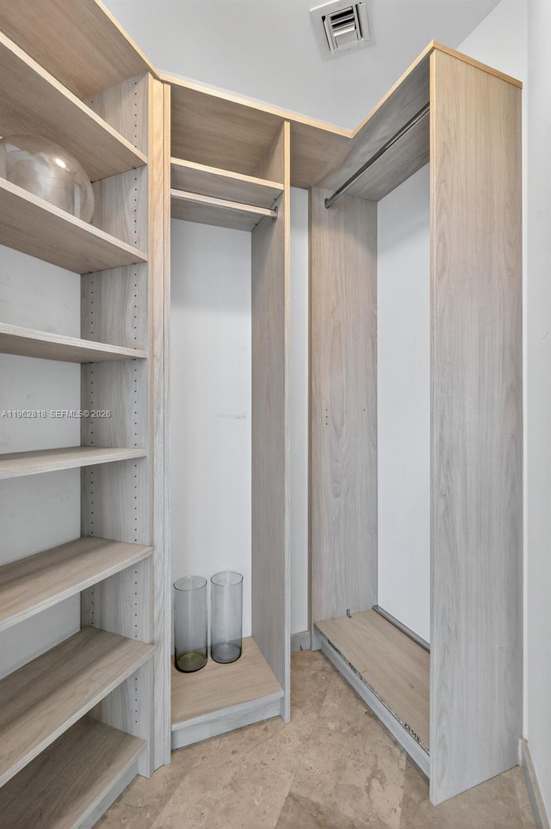 88 Southwest 7th Street, Unit 2402 Miami, FL 33130 - Photo 28 of 38 a view of walk in closet with empty racks