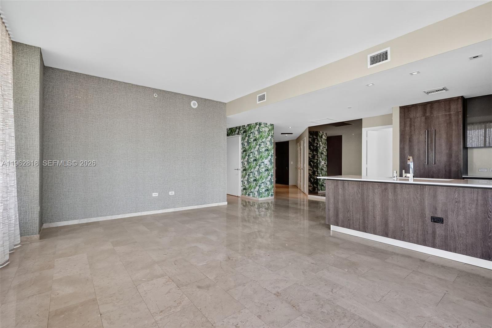 88 Southwest 7th Street, Unit 2402 Miami, FL 33130 - Photo 8 of 38 a view of an empty room with wooden floor