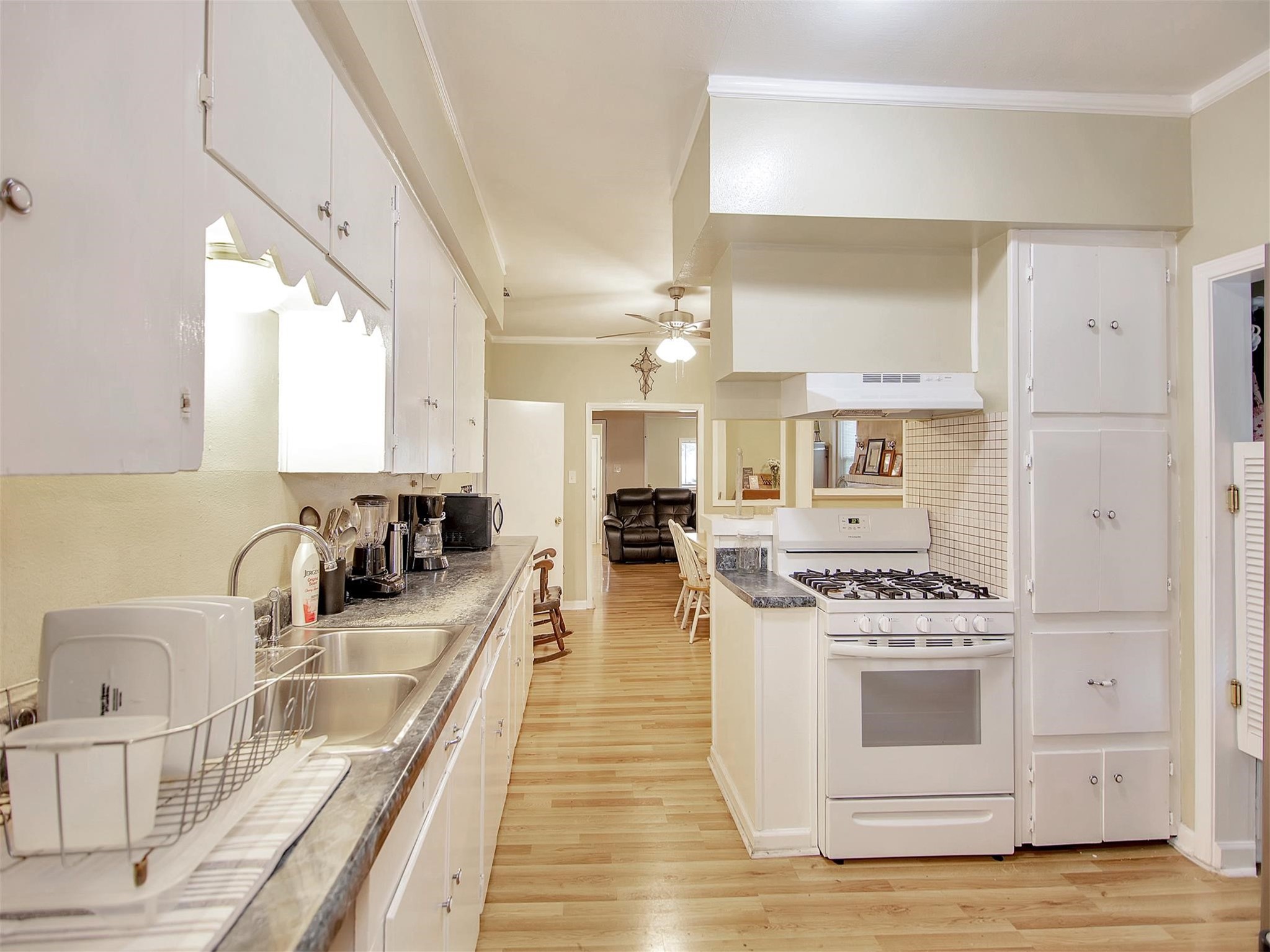 5207 McCormick Street Houston, TX 77023 - Photo 13 of 33 a kitchen with stainless steel appliances a stove a sink and a wooden floors