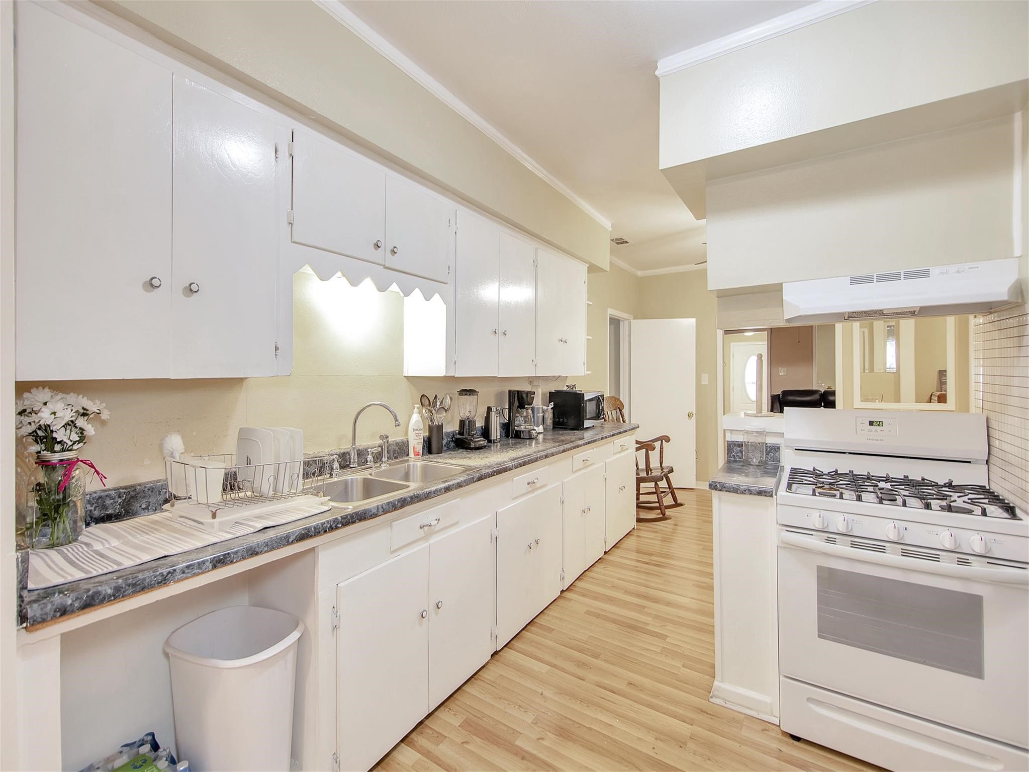 5207 McCormick Street Houston, TX 77023 - Photo 14 of 33 a large white kitchen with stainless steel appliances granite countertop a stove and a sink