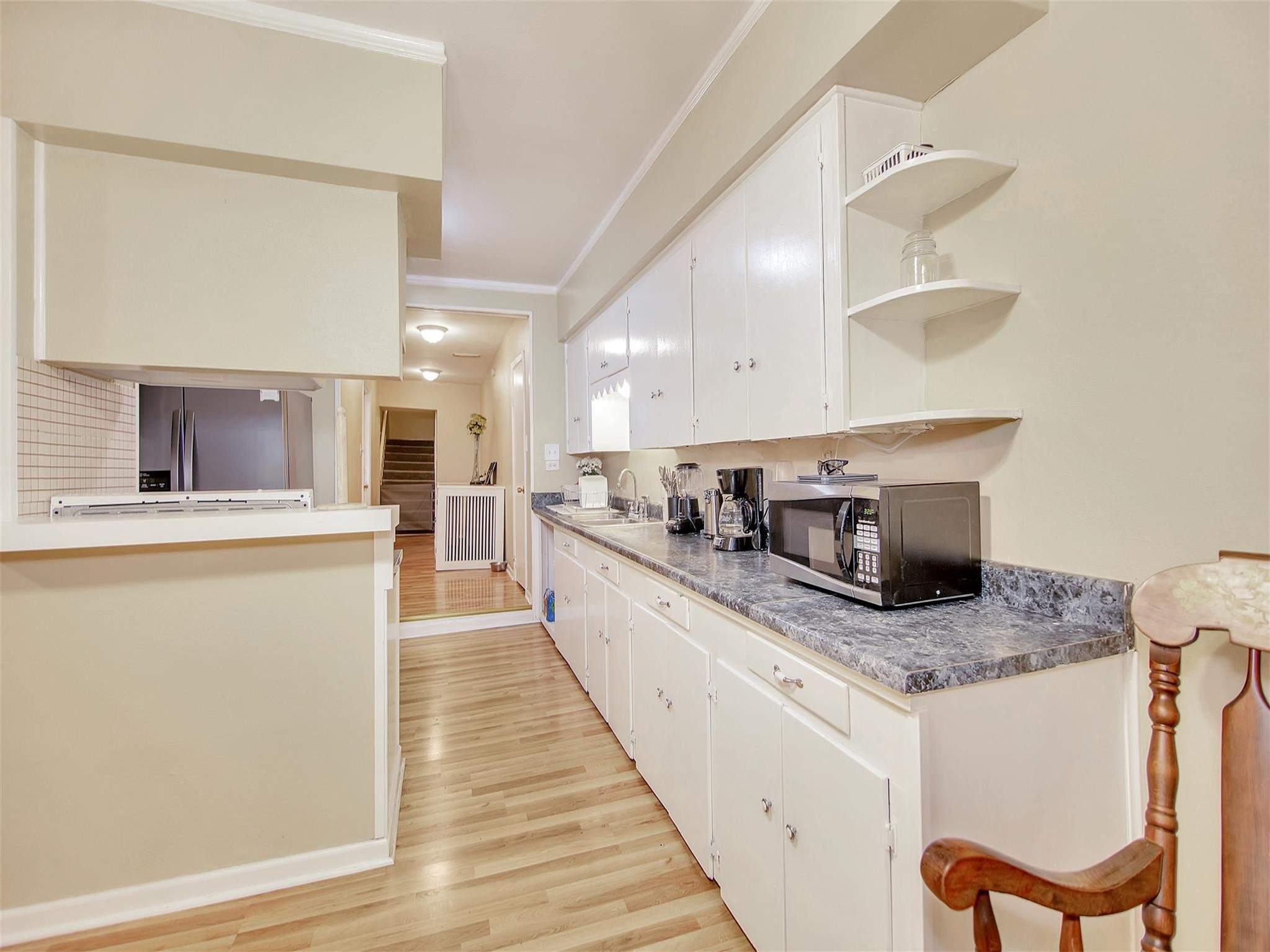 5207 McCormick Street Houston, TX 77023 - Photo 15 of 33 a large kitchen with stainless steel appliances granite countertop a stove a sink and a microwave