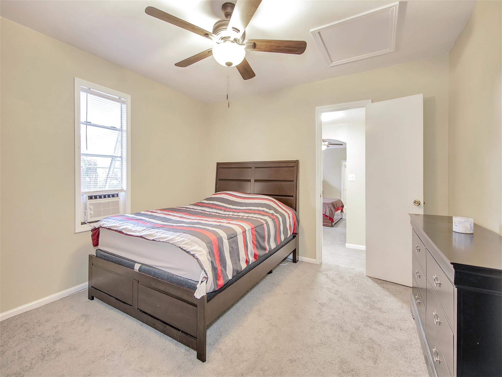 5207 McCormick Street Houston, TX 77023 - Photo 20 of 33 a bedroom with a bed and a chandelier