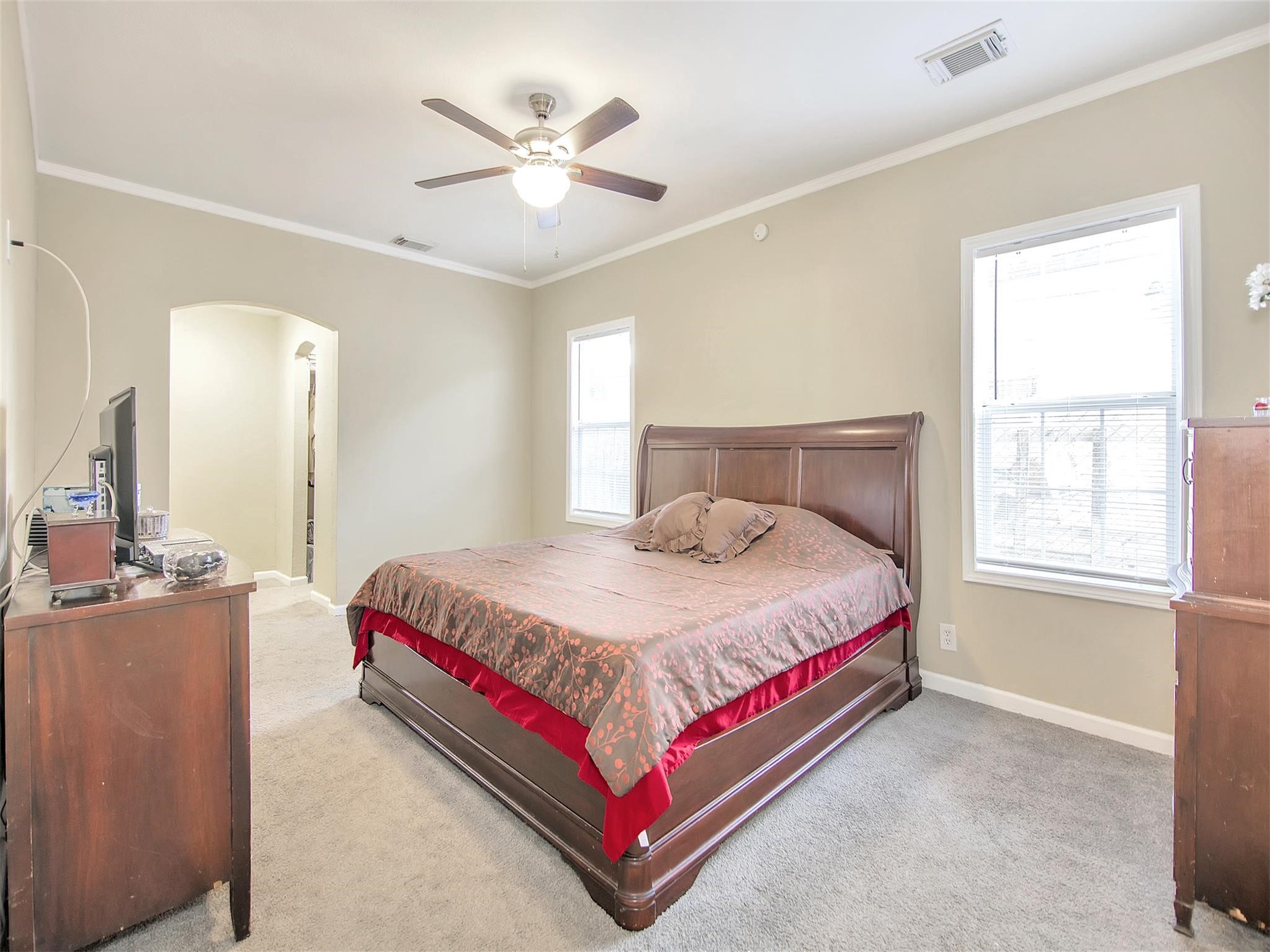 5207 McCormick Street Houston, TX 77023 - Photo 21 of 33 a bedroom with a bed chandelier and a window